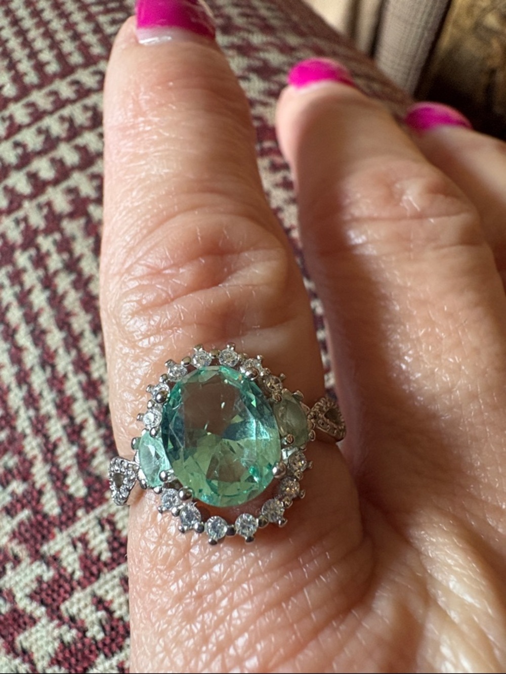 Sterling Silver Ring with Green Oval Gemstone and Halo Accents